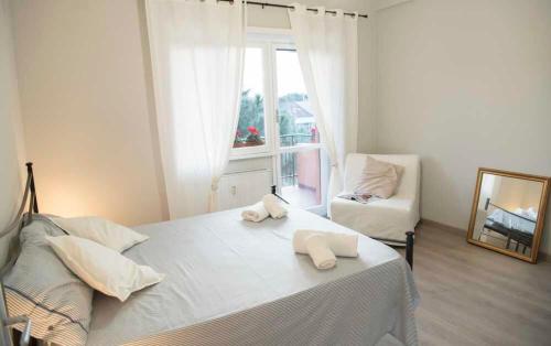 a bedroom with a bed with two towels on it at Green view apartment in Rome