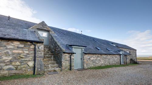 an old stone building with a slate roof at The Snug - Llyn Peninsula in Pistyll