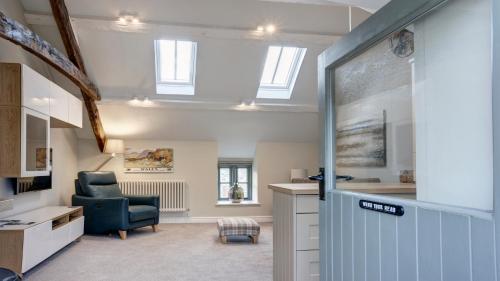 a living room with a blue chair and a desk at The Snug - Llyn Peninsula in Pistyll