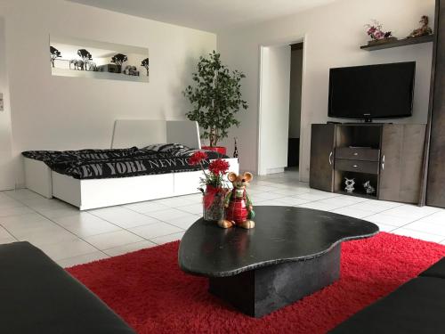 a living room with a bed and a red rug at Residenza San Remy in Unterkulm