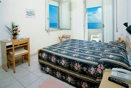 Postel nebo postele na pokoji v ubytování Hotel Oasi Ristorante Pizzeria