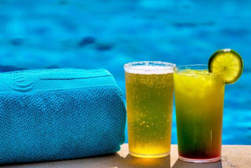 a pair of glasses of beer and a towel at Estelar Playa Manzanillo - All inclusive in Cartagena de Indias