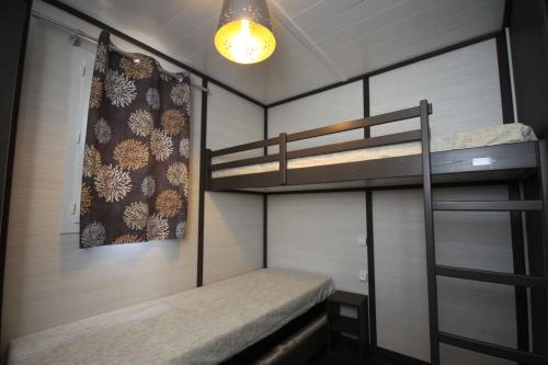 a bunk room with two bunk beds and a light at Lecci e Murta in Propriano