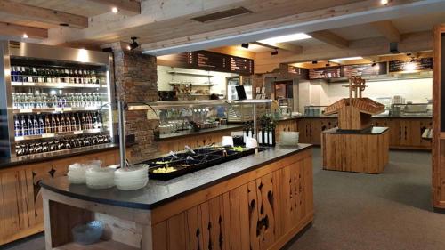 a large kitchen with a counter in a restaurant at Berggasthof Schatzbergalm in Thierbach