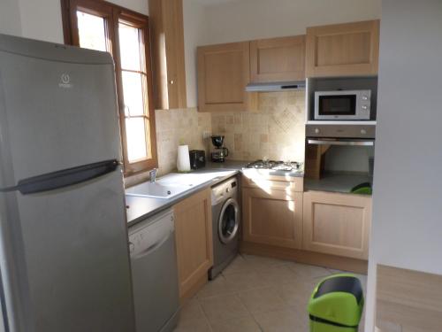 une cuisine avec un réfrigérateur et un lave-vaisselle dans l'établissement Charmante maison Solognote rénovée, à La Ferté-Saint-Aubin