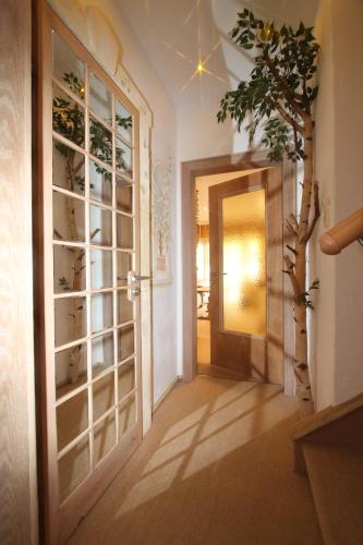 a hallway with an open door and a door to a room at Haus Sonnenschein in Grainau