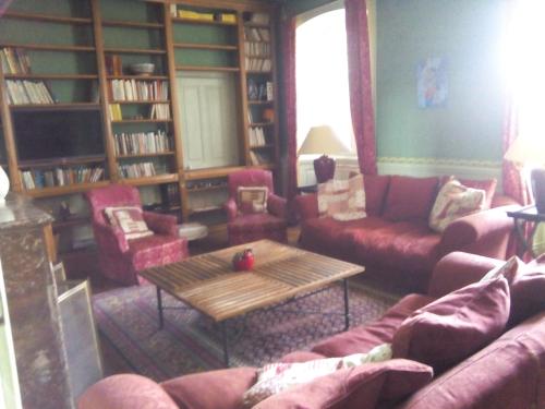 a living room with couches and a coffee table at Château Bel-Air in Villers-Farlay
