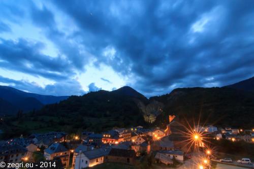 a town in the mountains at night at Hotel Rural El Portón de Murillo in Broto