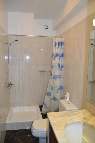 a bathroom with a sink and a toilet and a shower at Central Suite in Funchal 2N in Funchal