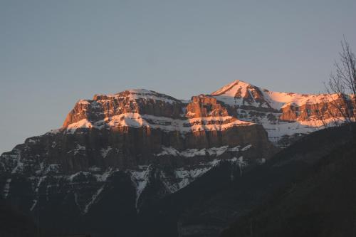a mountain with snow on top of it at Hotel Rural El Portón de Murillo in Broto