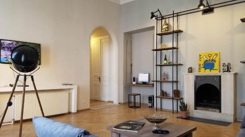 a living room with a fireplace and a table at Art House in Tbilisi City