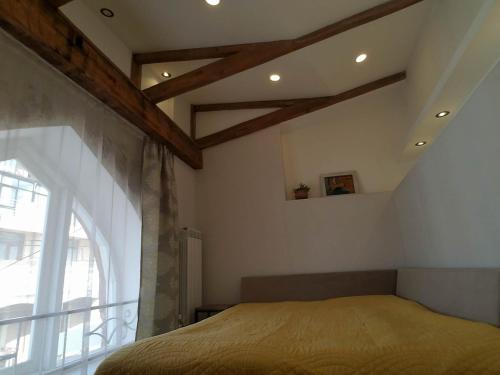 a bedroom with a bed and a large window at Art House in Tbilisi City