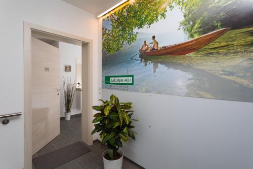 a hallway with a painting of a person in a hammock at NATURpur 4613 in Baldramsdorf