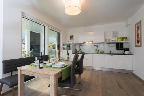 a kitchen and dining room with a table and chairs at NATURpur 4613 in Baldramsdorf