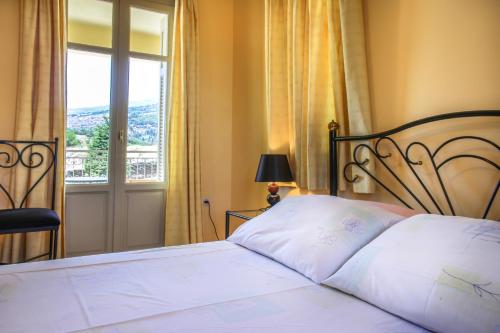 a bedroom with a large bed with a window at Villa View Studios in Andros