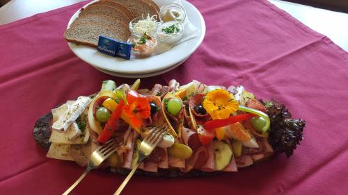 a plate of food on a table with a plate of food at Berggasthof Schatzbergalm in Thierbach