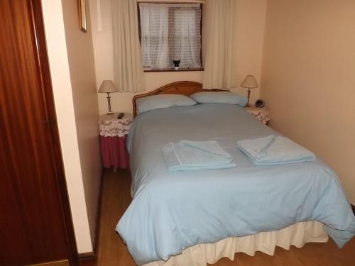 a bedroom with a bed with two towels on it at Peartree Farm in Aldwincle Saint Peter