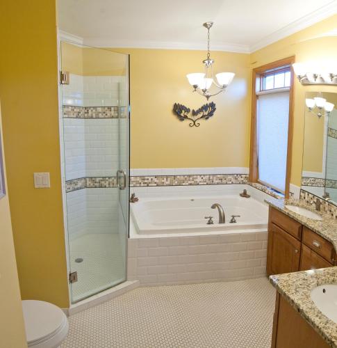 a bathroom with a tub and a shower and a toilet at DeSoto Beach Vacation Properties in Tybee Island