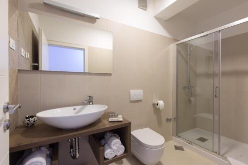 a bathroom with a sink and a toilet and a shower at B&B Villa Maris Punat in Punat