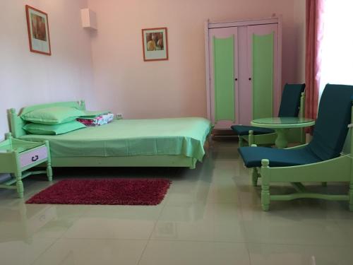 a bedroom with a bed and a table and chairs at Apartamente Mitu in Eforie Nord