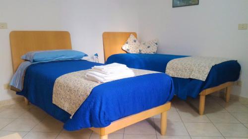 カルデラーラ・ディ・レーノにあるB&B Il Borghettoの- 青いシーツ付きのベッド2台(1室あたり)