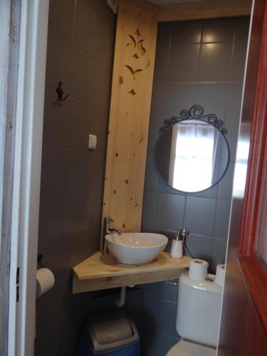 a bathroom with a sink and a toilet and a mirror at Schody Do Nieba in Zakopane