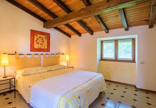 a bedroom with a large bed and a window at Casa Cinzia in Gravedona