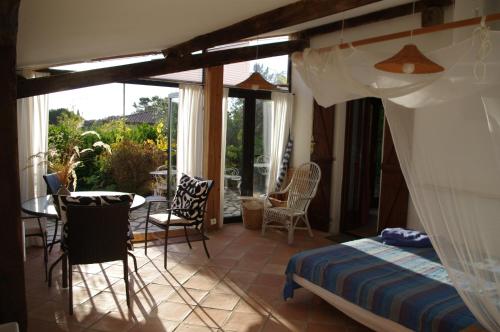 a bedroom with a bed and a table and chairs at Les Amandiers in Vallauris