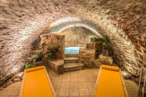 a cave with a swimming pool in a stone building at Hotel Blauer Engel in Aue