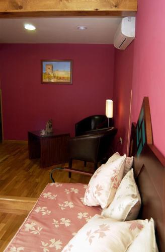 a bedroom with a bed and a desk with a piano at Hotel Spa La Casa Mudéjar in Segovia