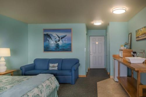 a bedroom with a blue bed and a blue couch at Inn of the Lost Coast in Shelter Cove
