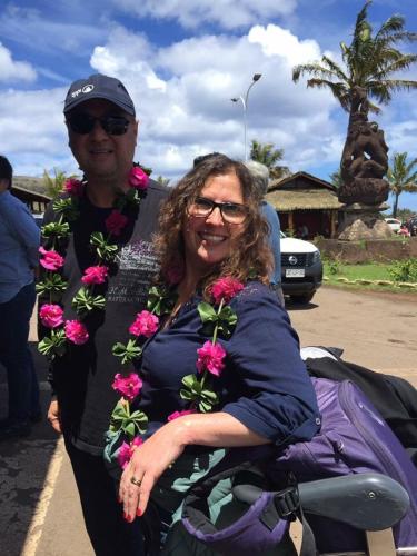 a man and a woman wearing flowers around their necks at Cabanas Hinariru Nui in Hanga Roa