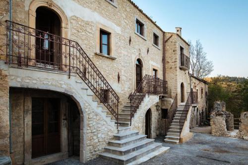 an old stone building with stairs on the side of it at Charme in Perillis in Popoli