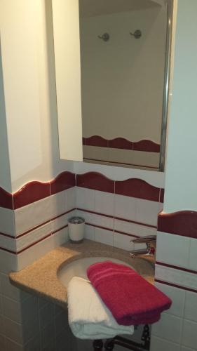 a bathroom with a sink with a mirror and towels at Casa Duomo in Amalfi