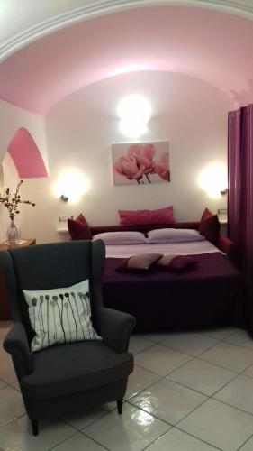a bedroom with a bed and a couch at Casa Duomo in Amalfi