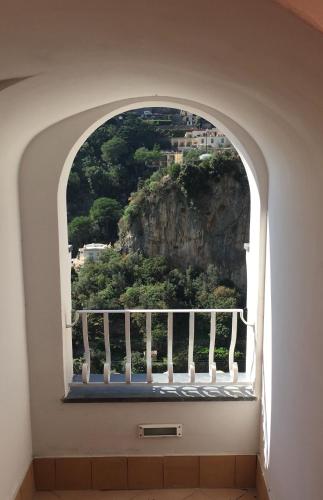 an arched window with a view of a mountain at Il Moro Di Positano in Positano