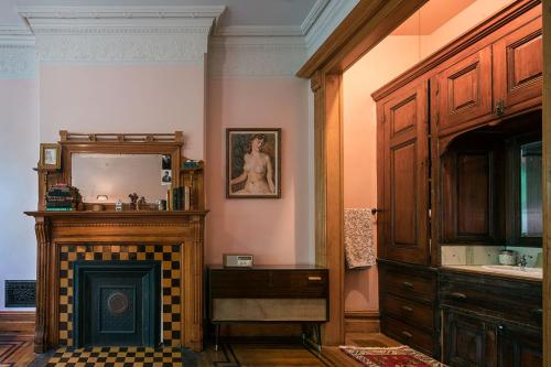 a living room with a fireplace and a mirror at The Harlem Flophouse in New York