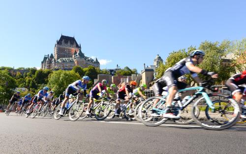 a group of people riding bikes down a street at Auberge Jeunesse La Belle Planete Backpackers Hostel in Quebec City