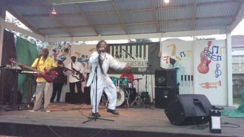 a man is performing on a stage with instruments at Drifters@One Mile in Negril