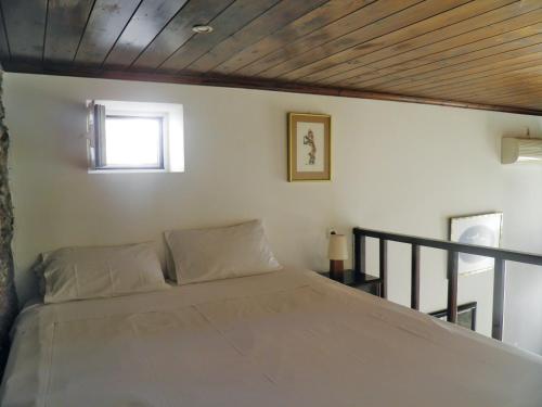 a bedroom with a large bed with a window at Ζoe Studios in Kýthira