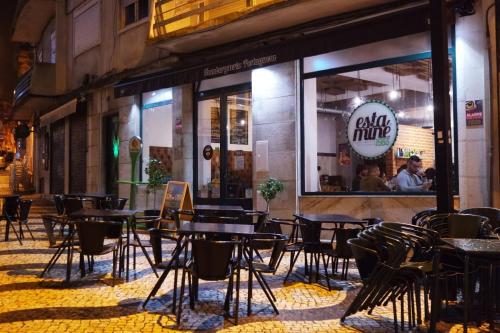 a group of tables and chairs outside of a restaurant at Apartamento Tejo in Cacilhas