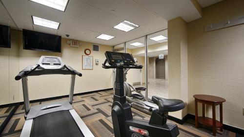 a gym with a treadmill and a bike in a room at Best Western Queens Court in Queens