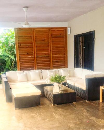 a living room with a white couch and a table at La Belle Créole in Las Galeras