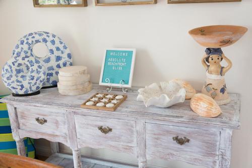 a wooden dresser with items on top of it at ABSOLUTE BEACHFRONT BLISS - NEWELL BEACH - 10 Metres to the Ocean in Newell Beach