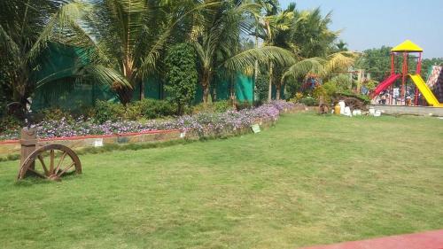 a playground with a roller coaster in a park at Sea Land Kihim in Alibaug