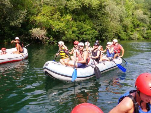 a group of people are rafting on a river at Apartment Simone in Split