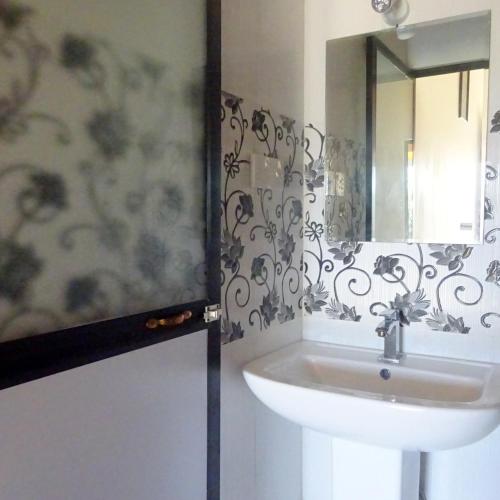 a bathroom with a sink and a mirror at Hotel Angel Inn Beach in Trincomalee