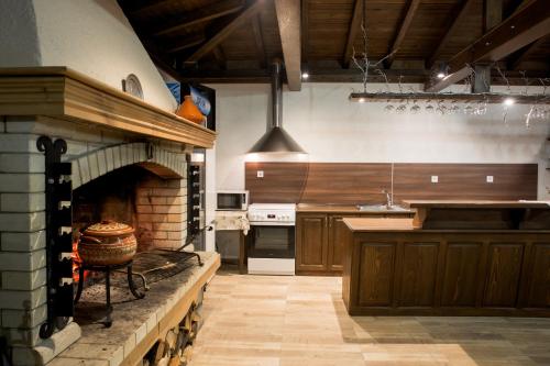 a large kitchen with a large brick oven in it at Guest House Panorama in Gela