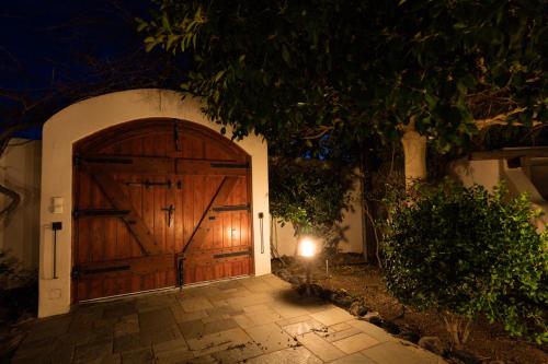 a large wooden door on a house at night at Aquaria Villa in Karterados