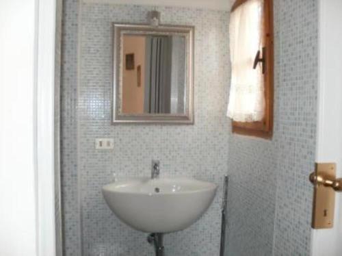 a bathroom with a white sink and a mirror at Dolce Bungalow R5915 in Pula